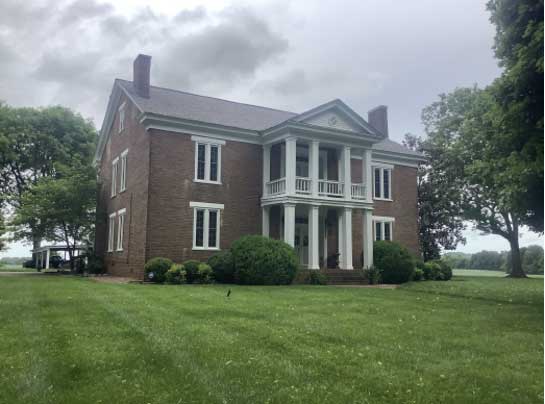 Three-quarter view of Harmony Hall and its impressive landscaping. 