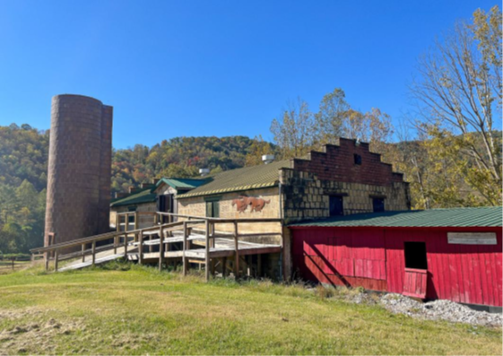 Façade and northeast elevations of the dairy barn and silo looking west.
