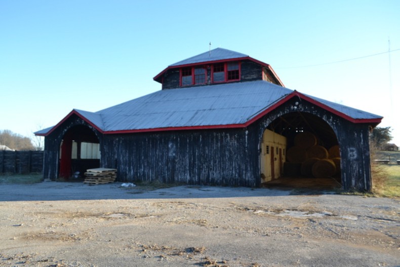 Entry to Polo Barn (E), showing cross gables and arched entryway facing northeast.