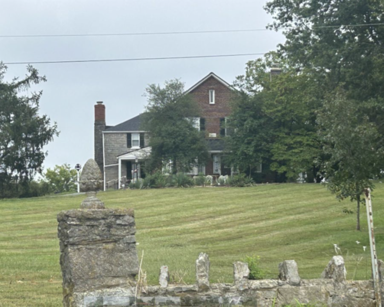 Bright's Inn, with late 19th century crenellated stone wall in foreground