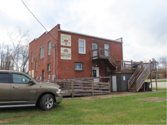 Southeast and northeast elevations of the commercial building, looking west.