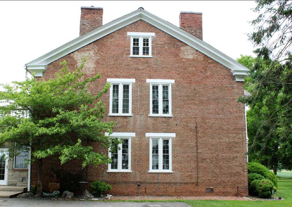 Greek Revival elements wrap around the front and secondary facades. Look at those windows!